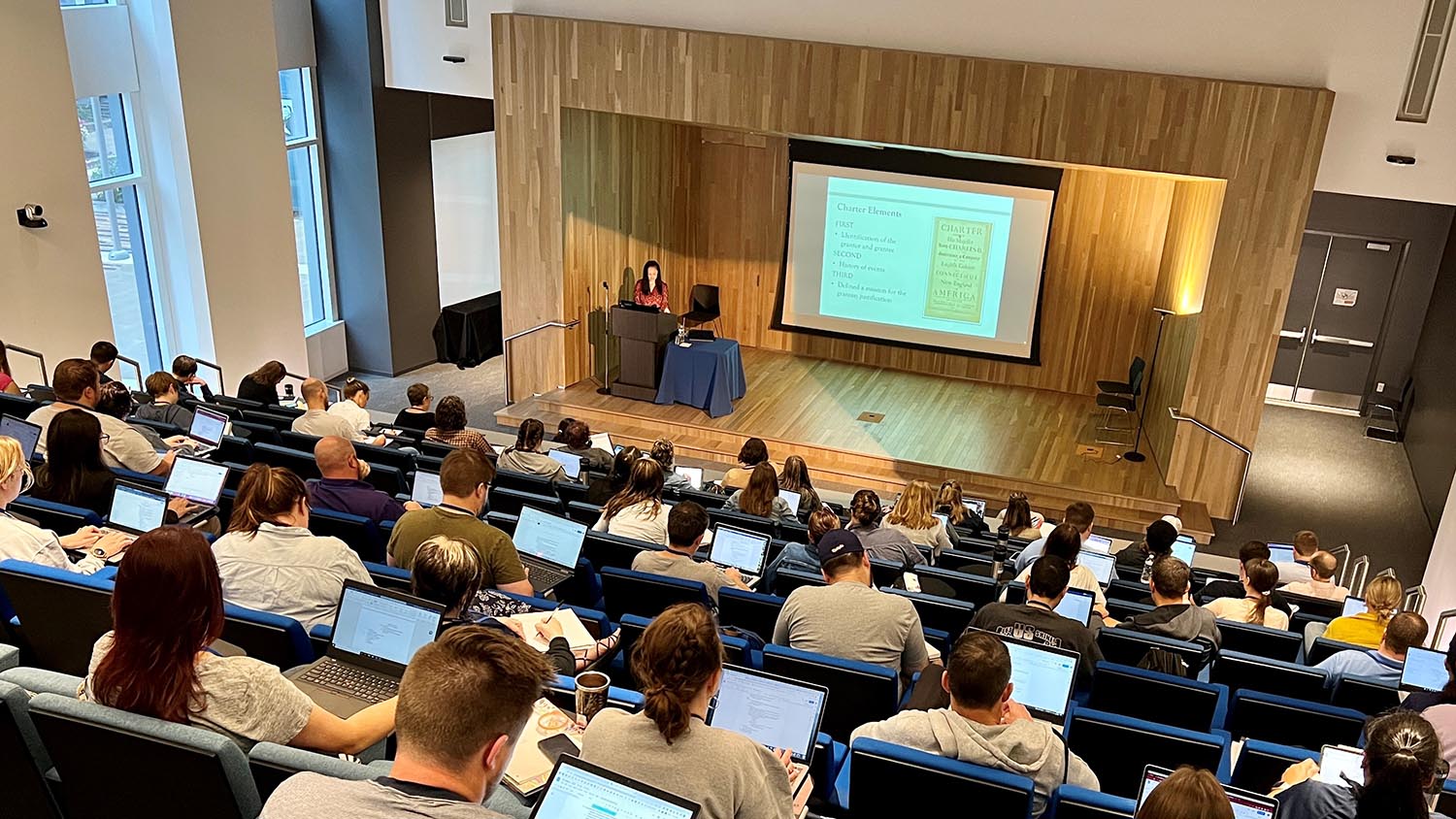 James Madison Fellows attend a lecture by Dr. Abbylin Sellers in the main classroom building auditorium